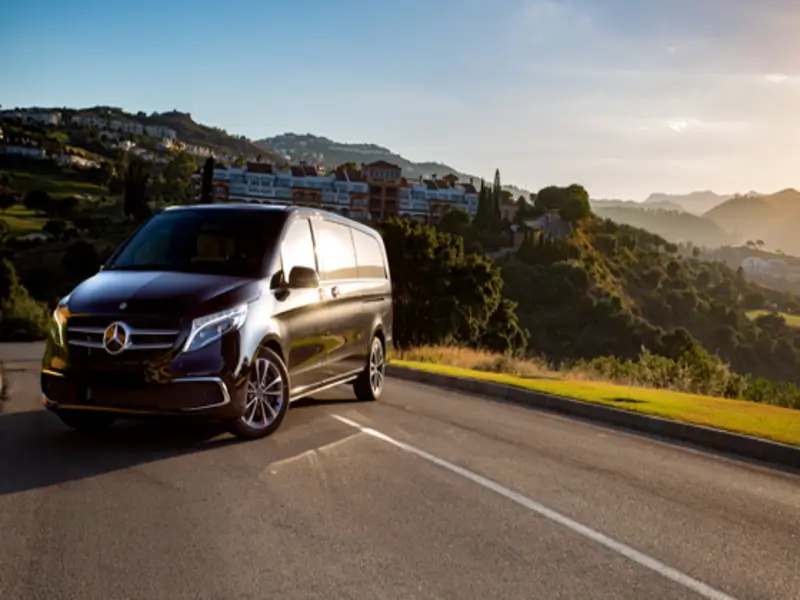 Luxury Mercedes V-Class van on a coastal road